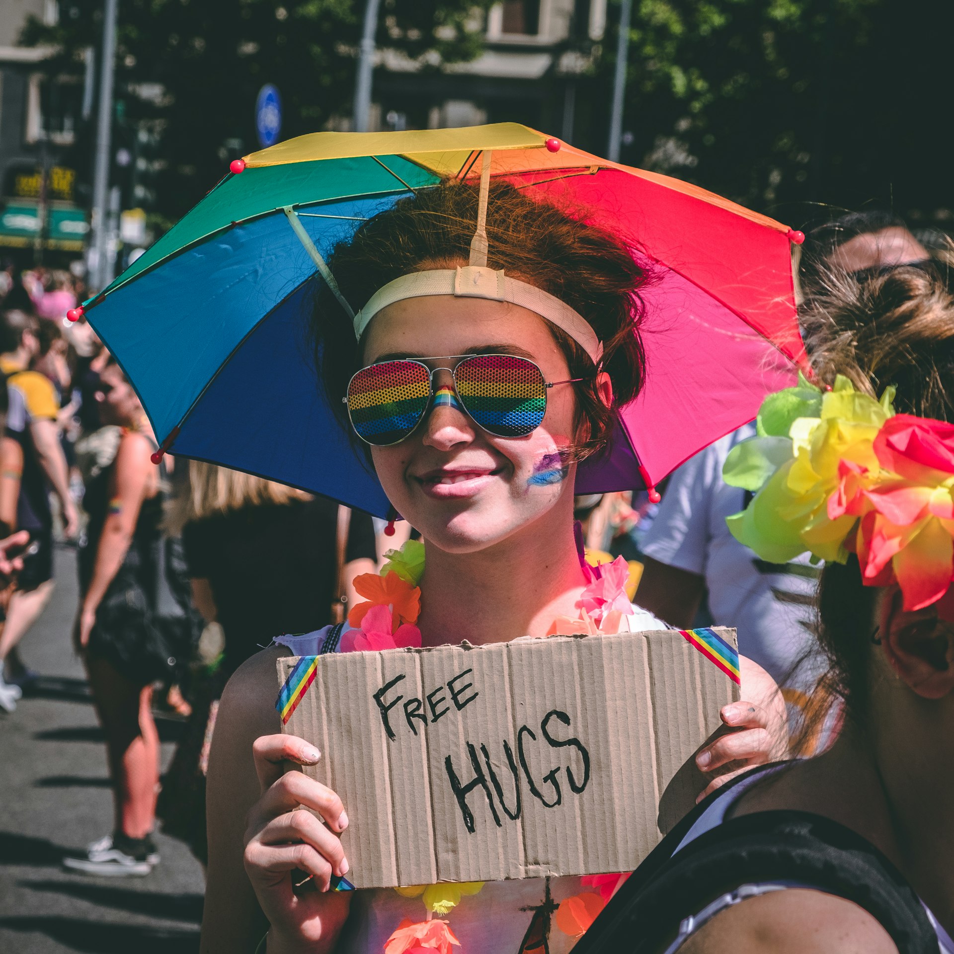 person holding Free Hugs signage